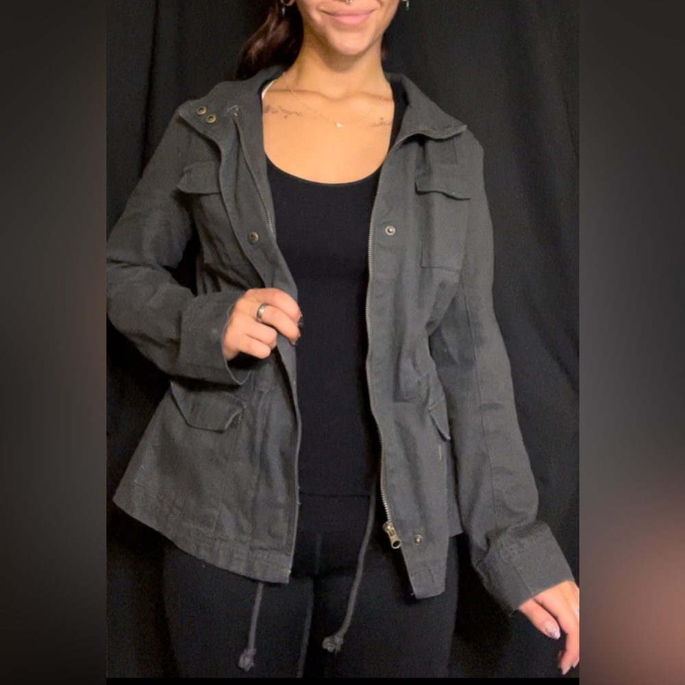 Women’s small jacket. Cinched waist. Buttons and zip up.